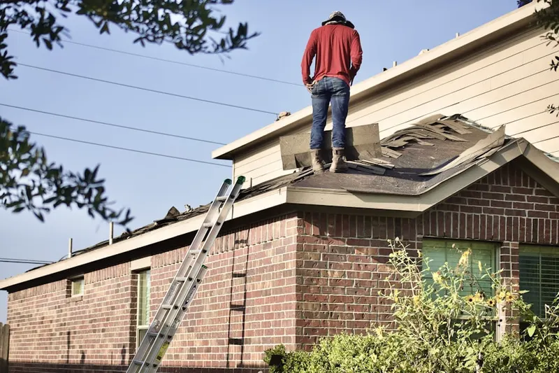 Professional roofer working on a residential roof in Centralville